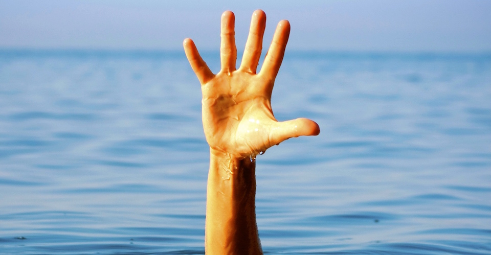 single hand reaching out of water