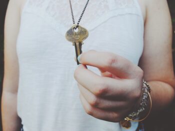 woman with key on a chain around her neck