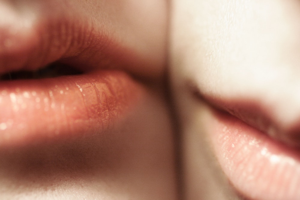 closeup of two faces showing just lips