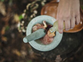 mixing herbs and oils with mortar and pestle