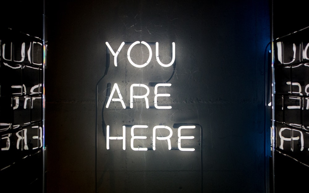You are here for a reason - neon sign saying You are Here