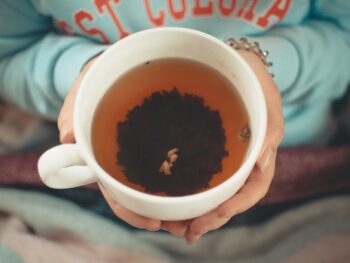 hands holding cup of tea